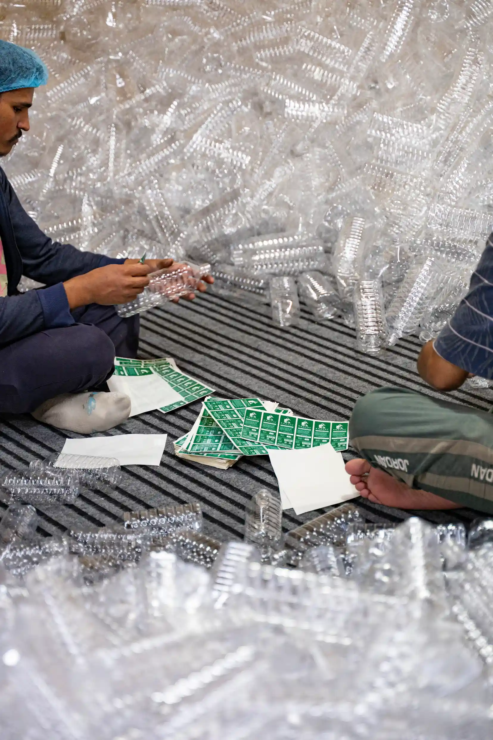 Khayul labels being applied to empty bottles